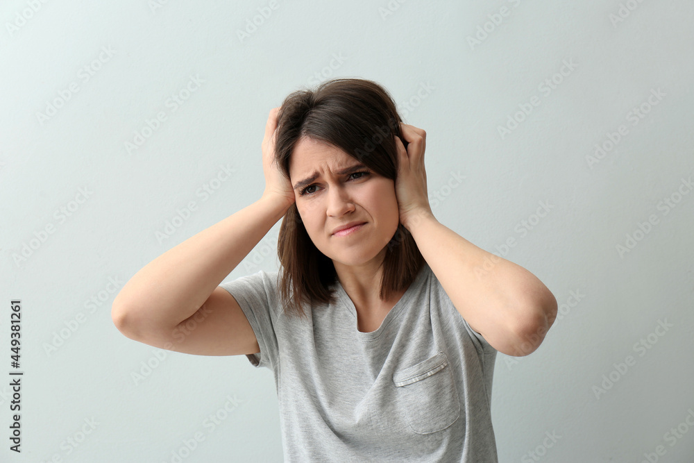 Young woman suffering from migraine on white background Young woman suffering from migraine on white background