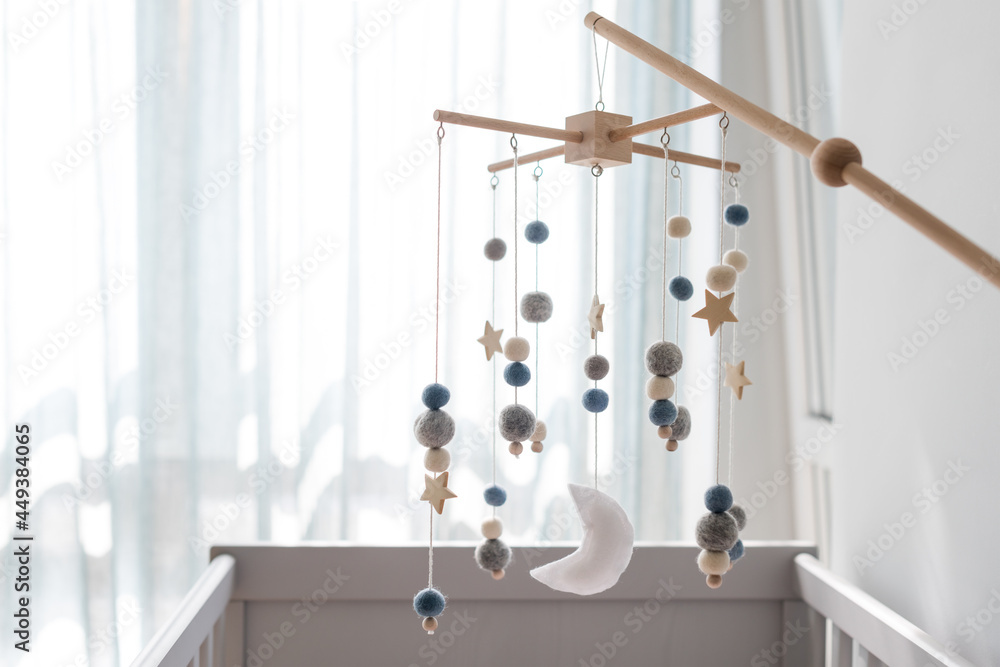 What hangs above a baby's crib hotsell