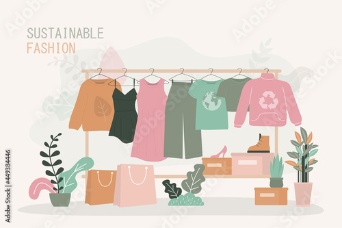Various clothes made from ethical materials hang on hanger. Shop with recycled textiles and clothing