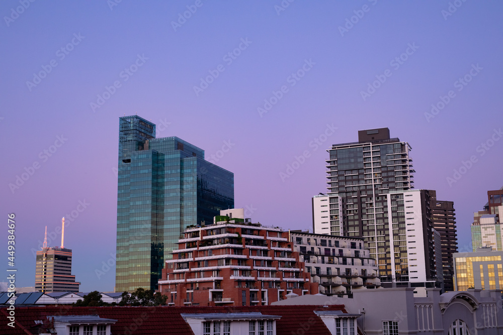 Modern high rise buildings in built up business district of modern city with dusk sky Modern high rise buildings in built up business district of modern city with dusk sky