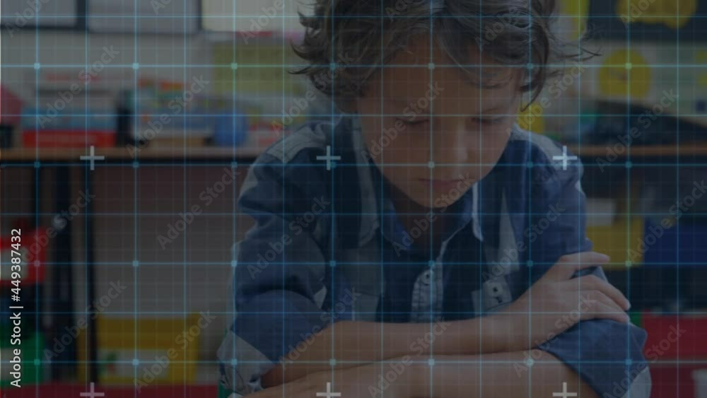 Grid network against caucasian boy studying at elementary school Grid network against caucasian boy studying at elementary school