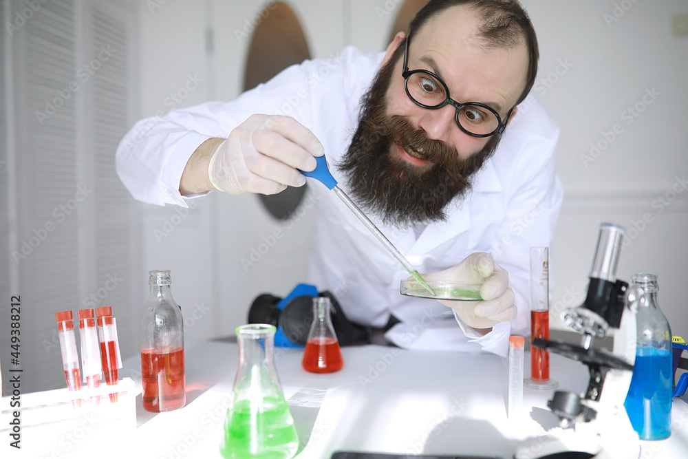 Chemist crazy. A mad scientist conducts experiments in a scientific laboratory. Performs research using a microscope. Chemist crazy. A mad scientist conducts experiments in a scientific laboratory. Performs research using a microscope.