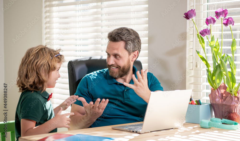 Fototapeta premium mature man teacher or dad helping kid son with school homework on computer, amazement