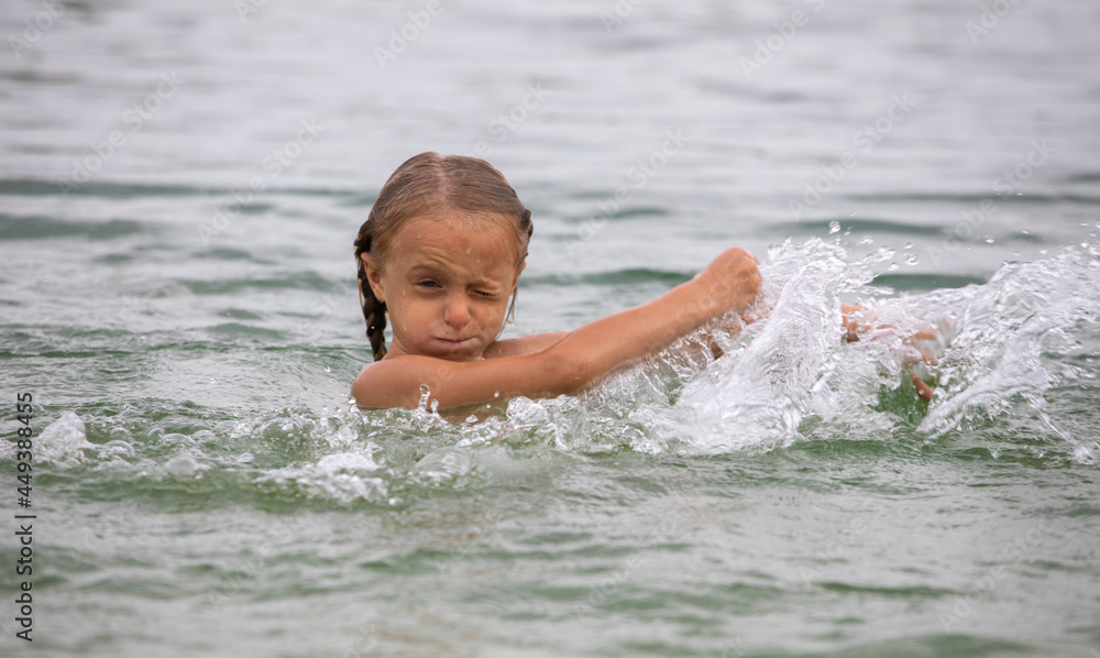 little happy girl splashing hands on the water, family fun. little happy girl splashing hands on the water, family fun.
