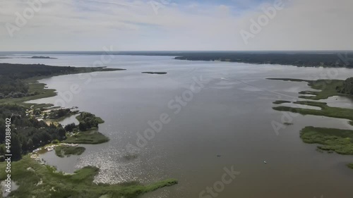 A bird's-eye view of the Siemianówka dam reservoir in the upper Narew valley.A bird's-eye view of two water pools separted track connected by a bridge.  photo