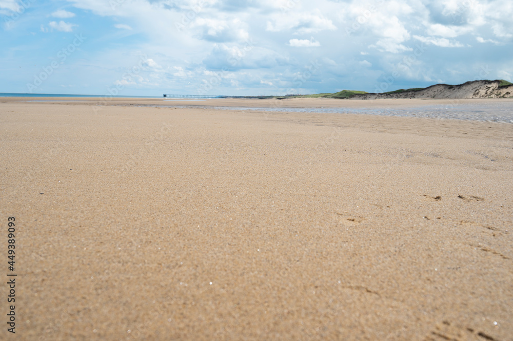 North Sea at the Crimdon beach, Hartlepool and Seaton Carew, England. Dark blue sky and sandy beach in United Kingdom