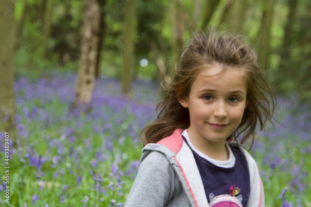 portrait of a pretty little girl with a bluebells forest background in sprintime portrait of a pretty little girl with a bluebells forest background in sprintime