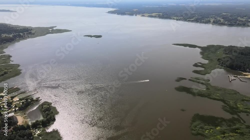 A bird's-eye view of the Siemianówka dam reservoir in the upper Narew valley.A bird's-eye view of two water pools separted track connected by a bridge.  photo