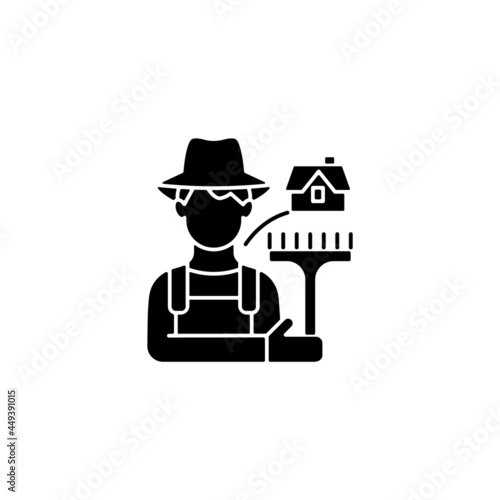 Rural workers black glyph icon. Man stands near barn. Labourer with tool. Rural area life. Farmer in village. Grow and produce food. Silhouette symbol on white space. Vector isolated illustration