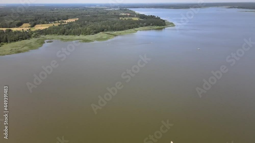 A bird's-eye view of the Siemianówka dam reservoir in the upper Narew valley.A bird's-eye view of two water pools separted track connected by a bridge.  photo