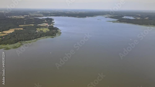 A bird's-eye view of the Siemianówka dam reservoir in the upper Narew valley.A bird's-eye view of two water pools separted track connected by a bridge.  photo