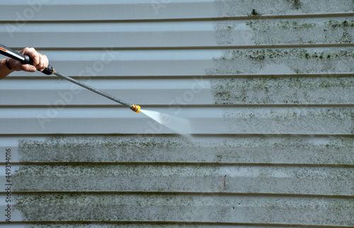 Cleaning the mold from the vinyl siding on this exterior wall is a job for the handyman or the professional. photo