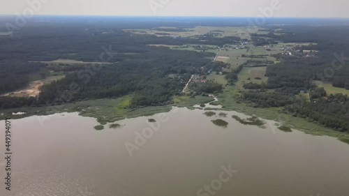 A bird's-eye view of the Siemianówka dam reservoir in the upper Narew valley.A bird's-eye view of two water pools separted track connected by a bridge.  photo