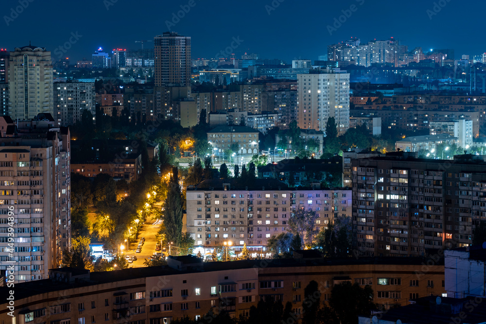 Night cityscape, lights from the windows of houses, stars in the sky, sleeping area. High quality photo