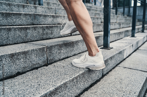 Legs of running person moving on stairs