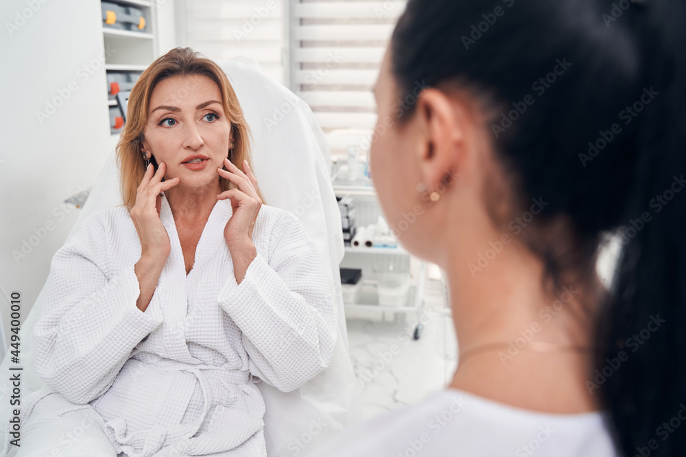 Pretty woman discussing beauty procedures with professional Pretty woman discussing beauty procedures with professional