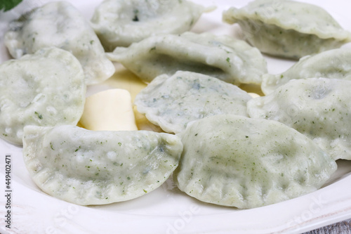 Green dumplings with spinach on the plate.