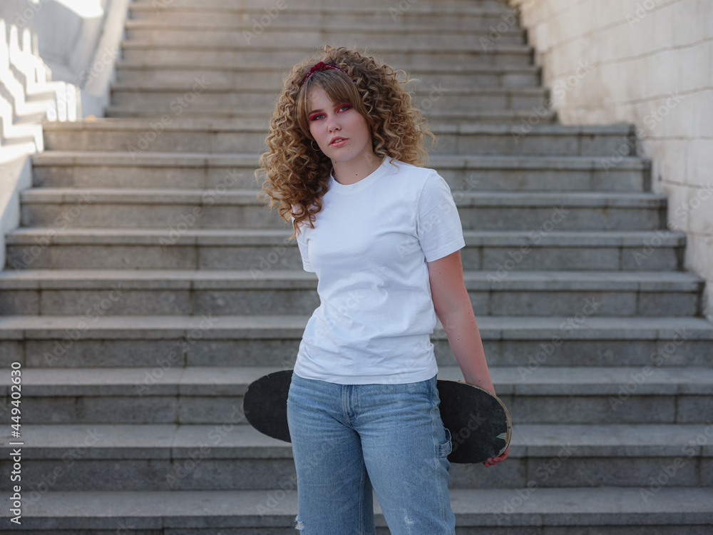Lady summer in the city, posing with a board, longboard skate. Lady summer in the city, posing with a board, longboard skate.