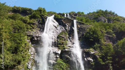 Water stream running from the beautiful Acquafraggia waterfall in Piuro, in the Bregaglia valley in Italy, before the ascent to the Maloja pass. It is a beautiful sunny summer day. photo