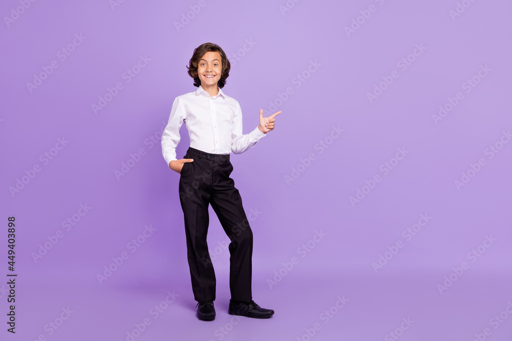 Full length photo of funky little brunet boy point wear formalwear trousers sneakers isolated on purple color background Full length photo of funky little brunet boy point wear formalwear trousers sneakers isolated on purple color background