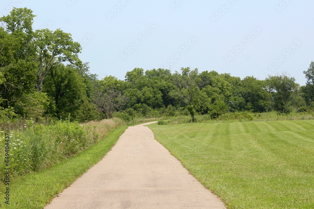 The long empty pathway in the countryside park.