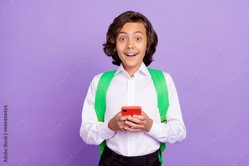 Photo of funny little brunet boy hold telephone wear formalwear bag isolated on purple color background Photo of funny little brunet boy hold telephone wear formalwear bag isolated on purple color background