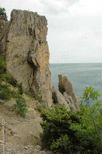 Scenic view of huge cliffs and sea. Sea bay surrounded by rocky mountains. The Black Sea coast is surrounded by rocks and mountains. Rocky shore, ripples on the sea water. Crimea. The Golitsyn Trail