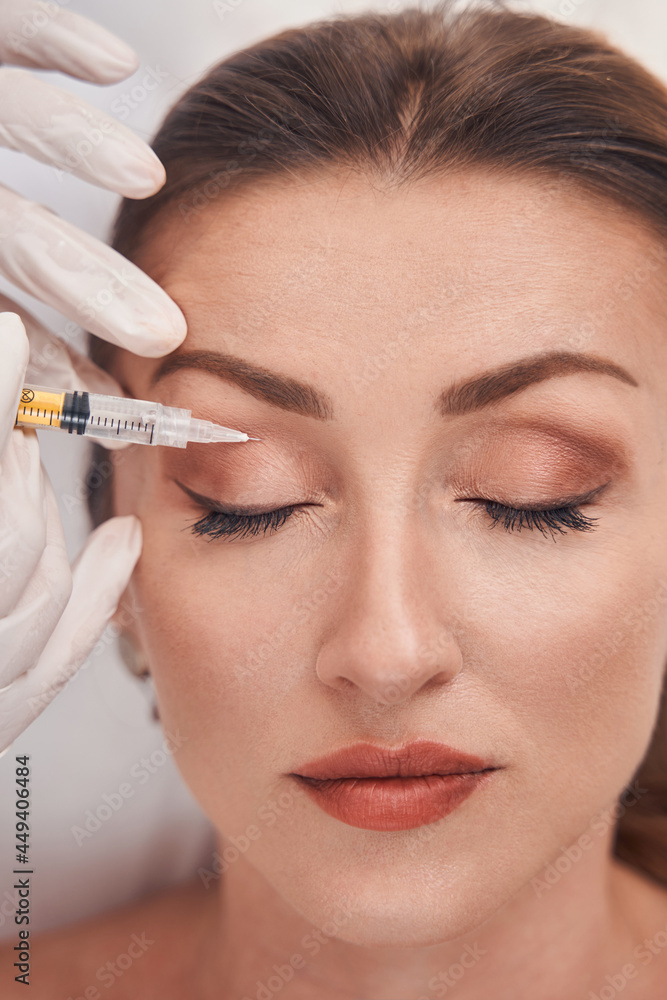 Pretty young lady doing mesotherapy in professional clinic Pretty young lady doing mesotherapy in professional clinic