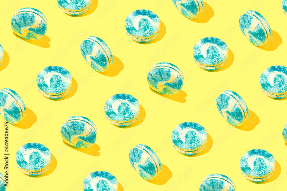 Creative pattern made of colorful macaroons on yellow background. Dessert and confectionary concept. Creative pattern made of colorful macaroons on yellow background. Dessert and confectionary concept.