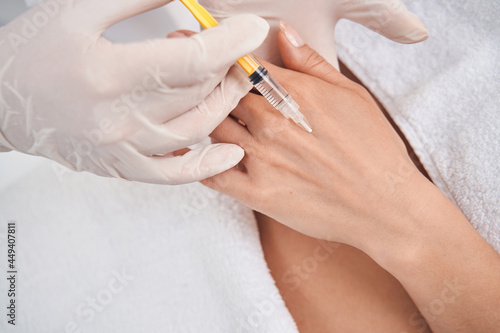 Cosmetologist doing anti age injections for woman body
