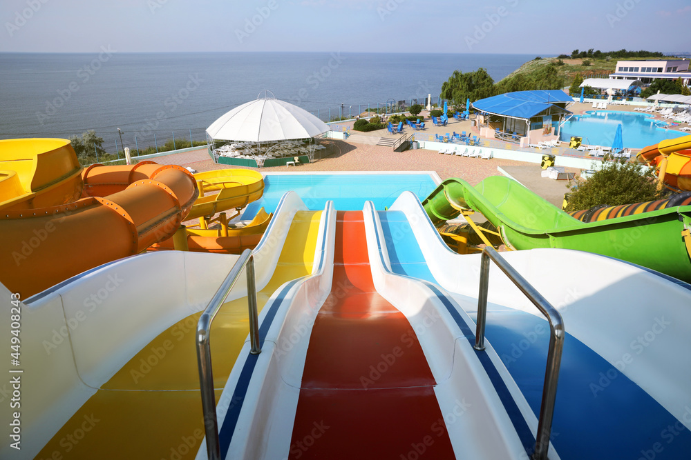 Colorful slides in water park on sunny day