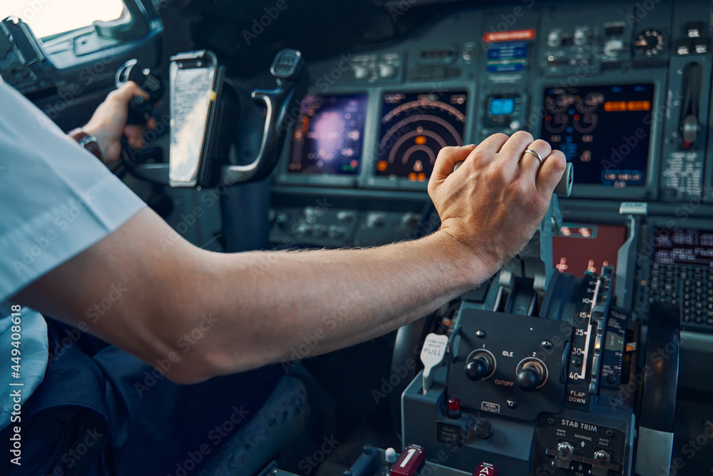 Fototapeta premium Aviator seated in the flight deck piloting an aircraft