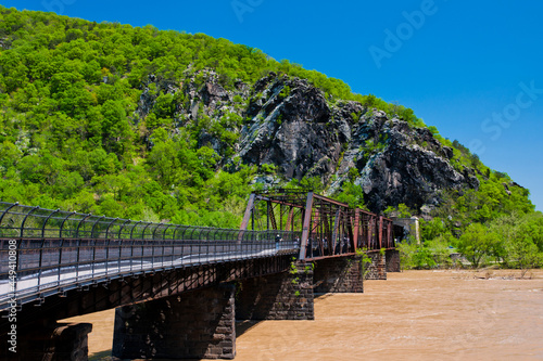 Train and pedestrian bridge over a flooded Potomac River, Harpers Ferry, West Virginia. photo