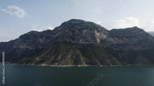 Wallpaper Mural Aerial view of a calm lake water surface of a turquoise color. Action. Breathtaking summer scenery with the mountain slopes and a water reservoir on cloudy sky background. Torontodigital.ca