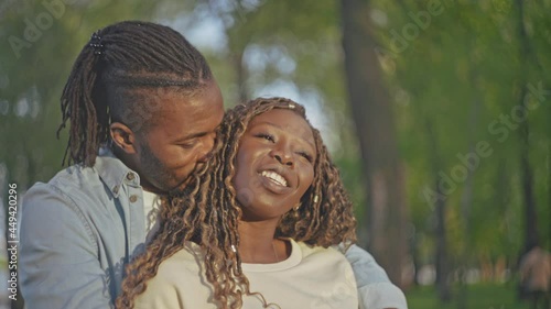 Happy black couple embracing in park, admiring beautiful sunset, romantic date