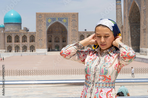 Muslim girl puts a scarf on her head photo