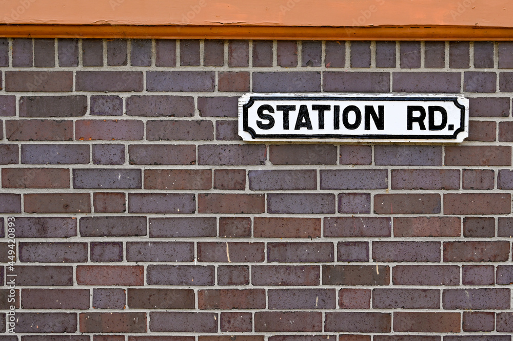 Station Road nameplate attached to a brick wall. No people. Station Road nameplate attached to a brick wall. No people.