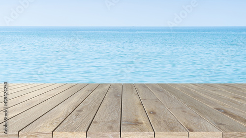 Wooden surface display table, sea backdrop, summer product display concept..