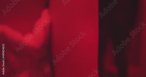 Unidentified woman in towel with gun points the gun at man in a photo dark room. Red Room, Silencer, Stylistic spy movie or film noir. (Shot on RED) 4K photo