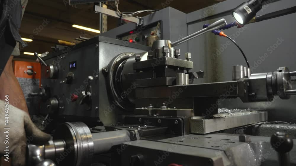 Metalworking plant.Workers at the machines process the parts.CNC Machine Metalworking plant.Workers at the machines process the parts.CNC Machine