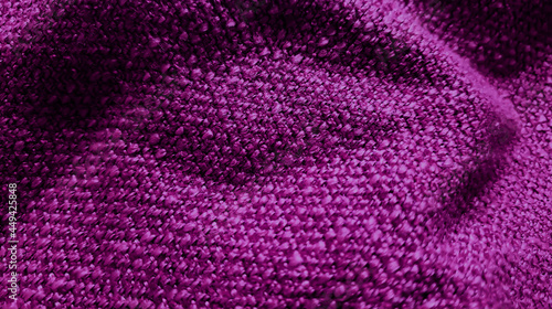 close up yarn violet textile fabric background showing beautiful wavy or crumpled pattern. wool fabric texture close up background. purple comfortable style cloth. wavy folds material.