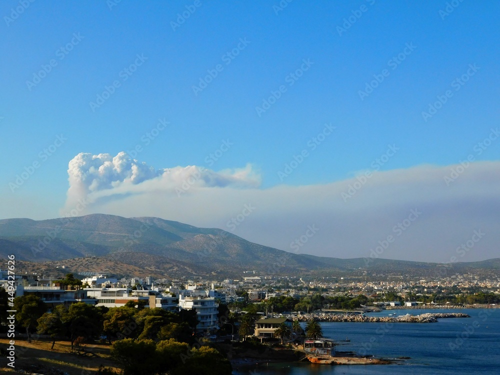 Smoke cloud from a forest wildfire over the town of Varkiza in Attica, Greece