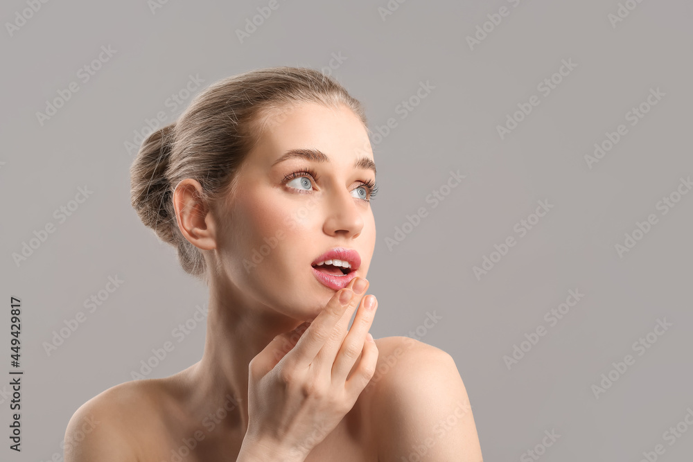 Portrait of beautiful young woman on grey background Portrait of beautiful young woman on grey background