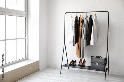 Obraz na plátně Rack with stylish clothes in room