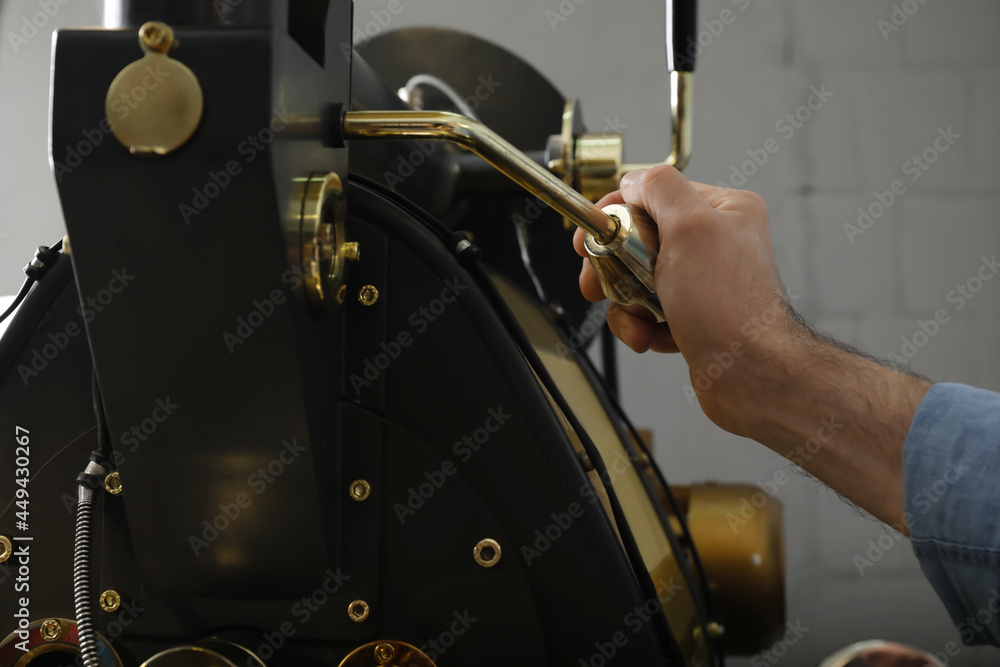 Senior man using modern coffee roaster Stock Photo Adobe Stock