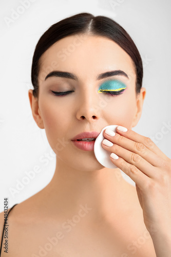 Beautiful young woman remov...