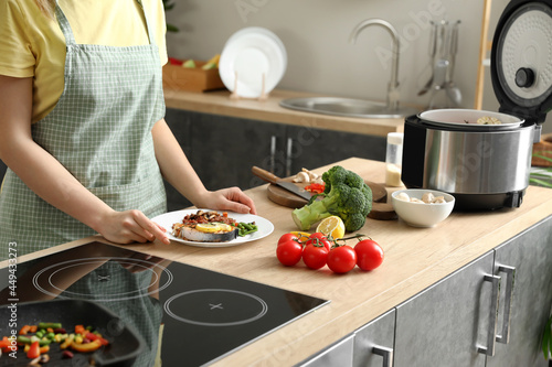 Woman with tasty dish in ki...