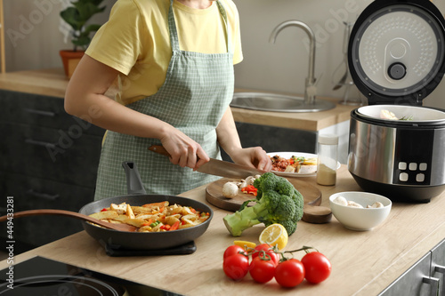Woman cutting mushroom in k...