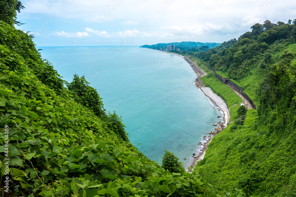 Scenic view of the Black Sea coast, Green Vegetation and Railroad From Botanical Garden in Batumi, Adjara Georgia. Beautiful Summer day, paradise landscape with turquoise water. No people