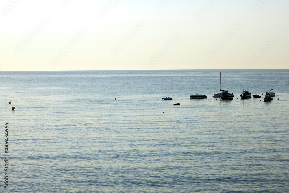 Morning landscape, sunrise over the river, sandy beach near the shore are boats.